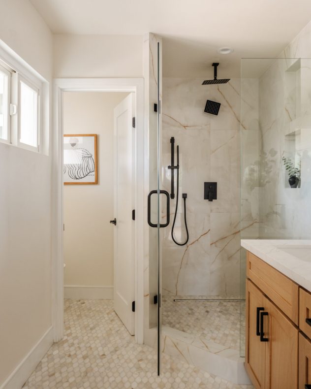 Primary bathroom with soaking tub, walk-in shower, and spa-like modern finishes